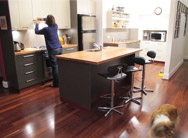 Image of a customer in her kitchen designed by Q Designs