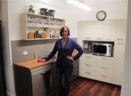Customer smiling in her newly fitted Q Designs Kitchen